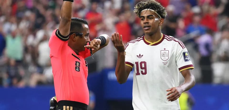 Árbitro mostrando tarjeta mientras jugador discute