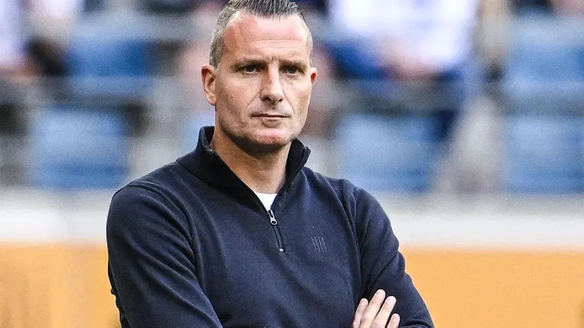 Entrenador observando el partido con los brazos cruzados