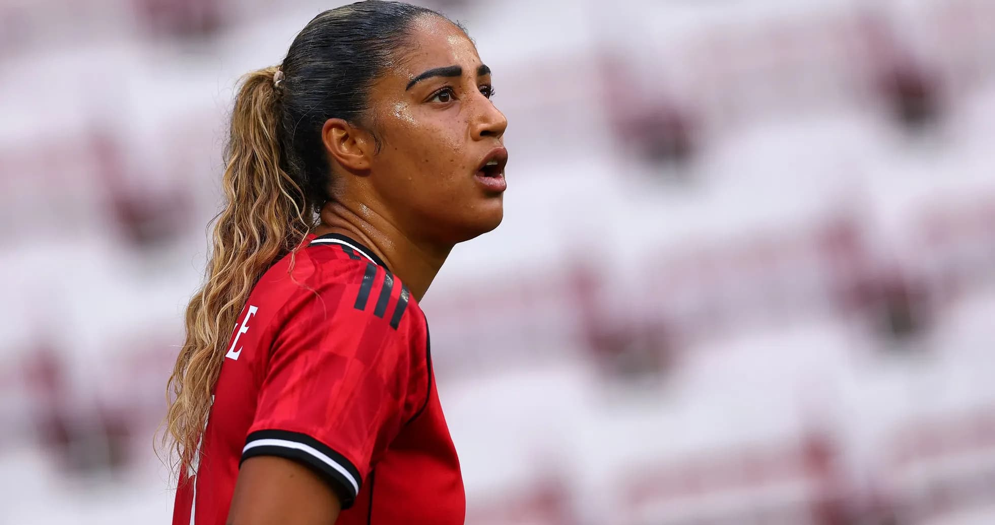 Jugadora con camiseta roja en el campo