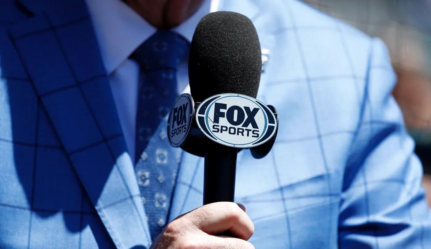 Mic with FOX Sports logo held by a person