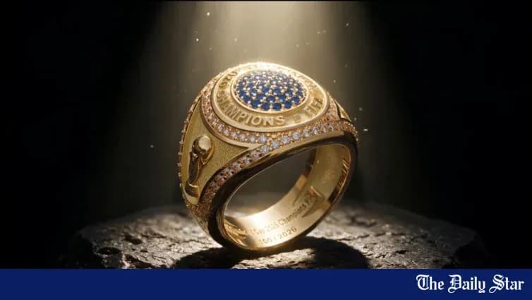 An ornate championship ring displayed on a pedestal