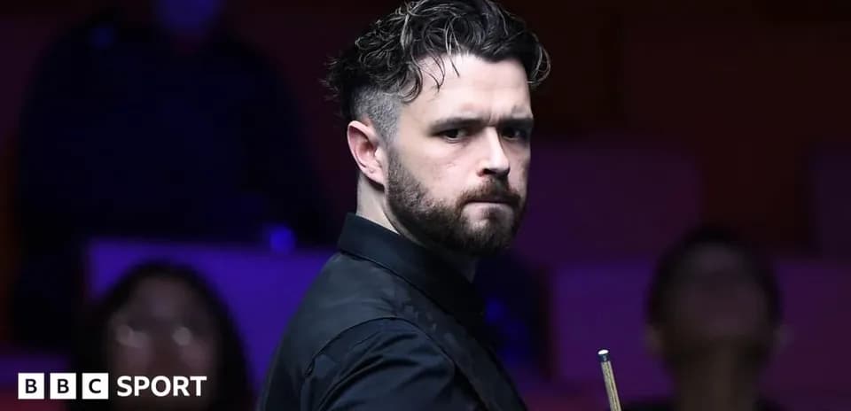 Jugador de snooker sosteniendo un taco en el escenario