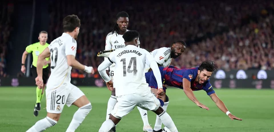 Jugador de Barcelona cae rodeado por defensores del Real Madrid