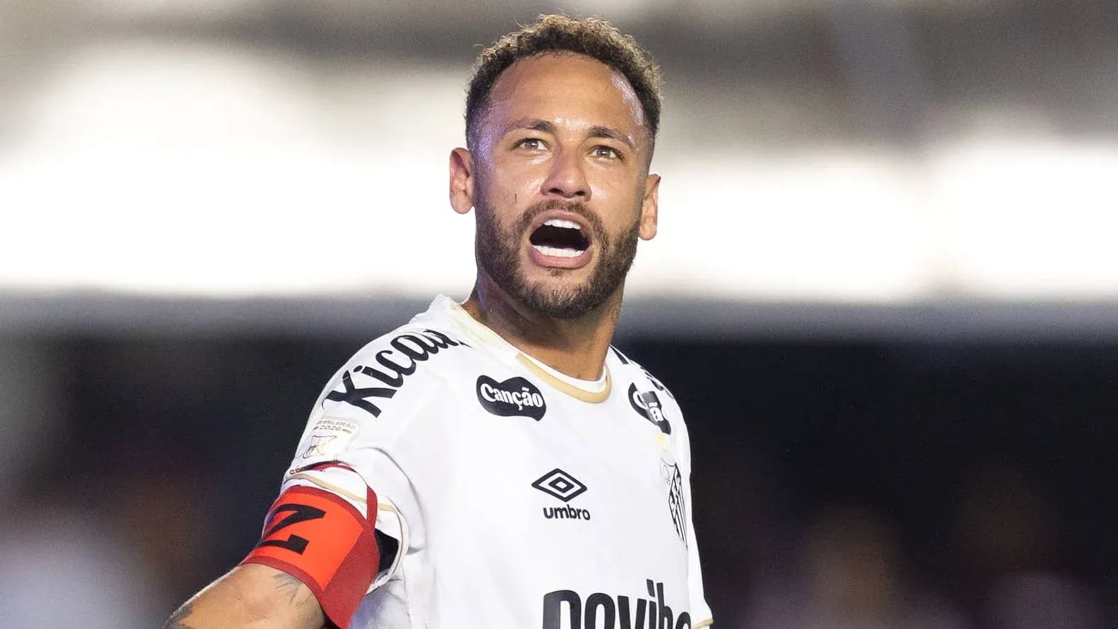 Jugador en uniforme de fútbol gritando durante el partido