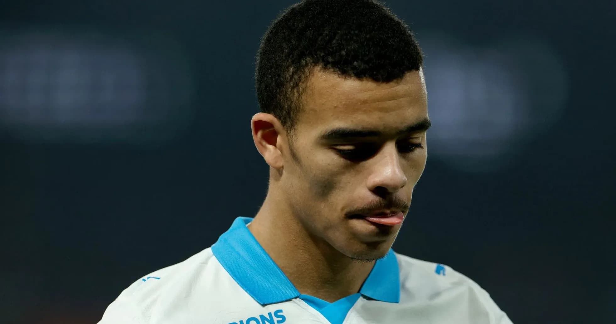 Jugador con camiseta blanca mirando hacia abajo