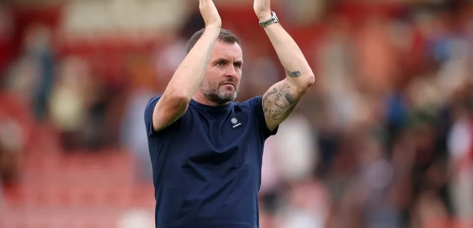 Entrenador aplaudiendo a la afición después del partido