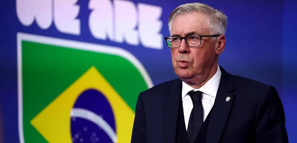 Entrenador hablando frente a bandera de Brasil