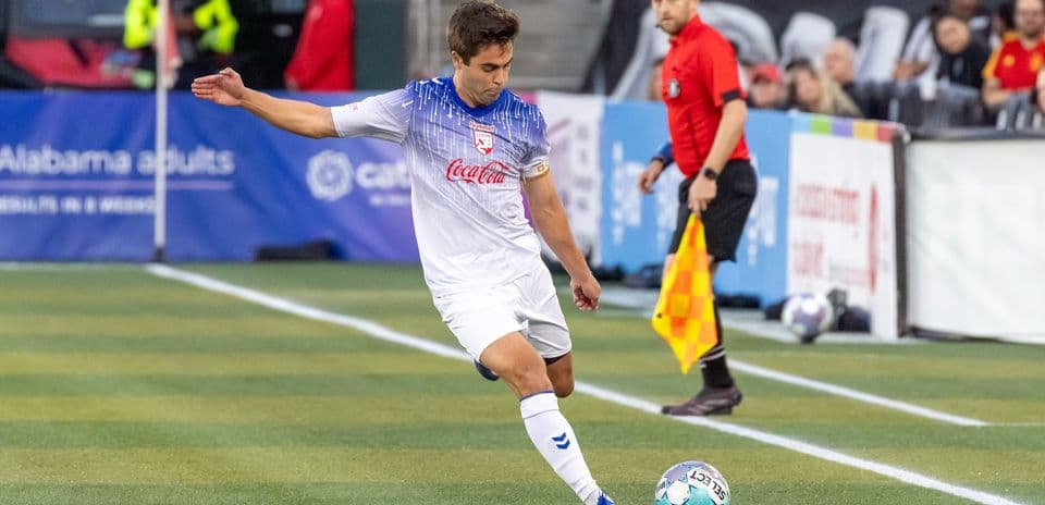 Jugador de fútbol ejecutando un tiro en el partido