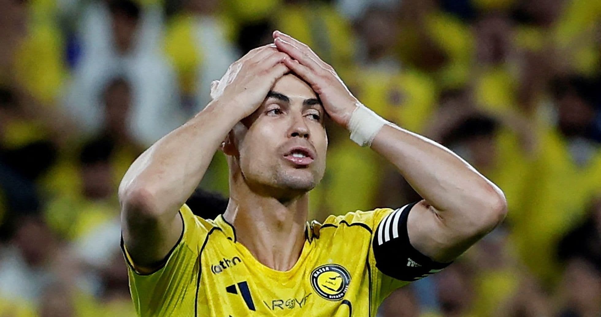 Jugador sosteniendo la cabeza en frustración durante el partido