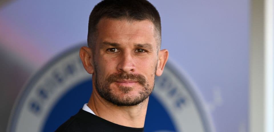 Jugador posando con fondo de club deportivo