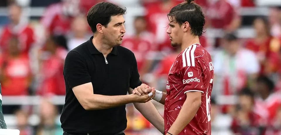 Entrenador hablando con jugador en el campo