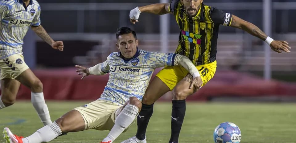Jugadores compitiendo por el balón en el partido