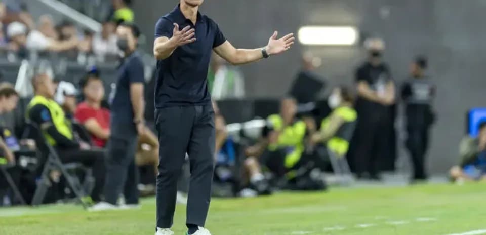 Entrenador dirigiendo desde la línea de banda