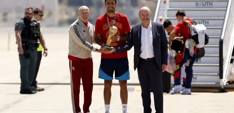 Jugadores recibiendo trofeo en aeropuerto