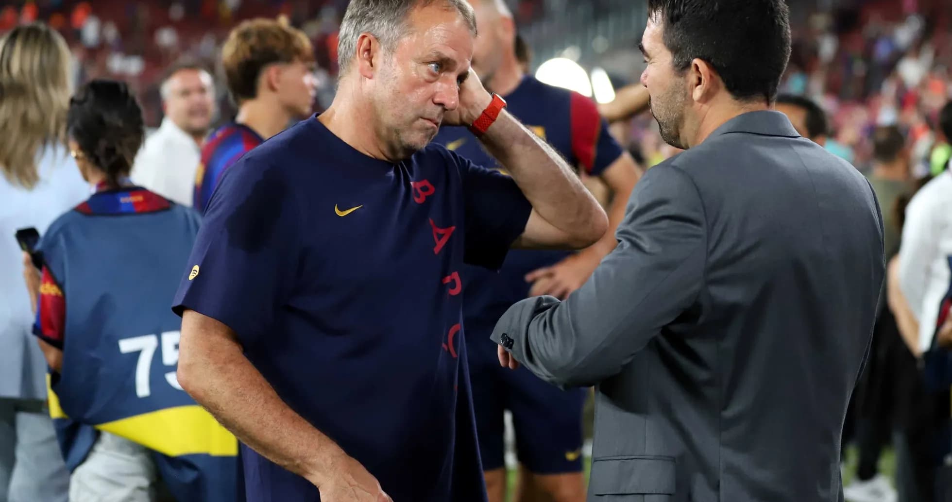 Entrenador conversando con otro en el campo