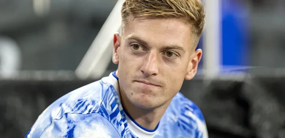 Jugador sentado en el banquillo con camiseta azul