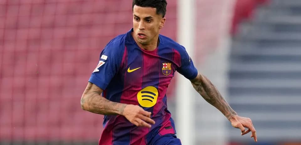 Jugador de Barcelona corriendo con el balón en el campo