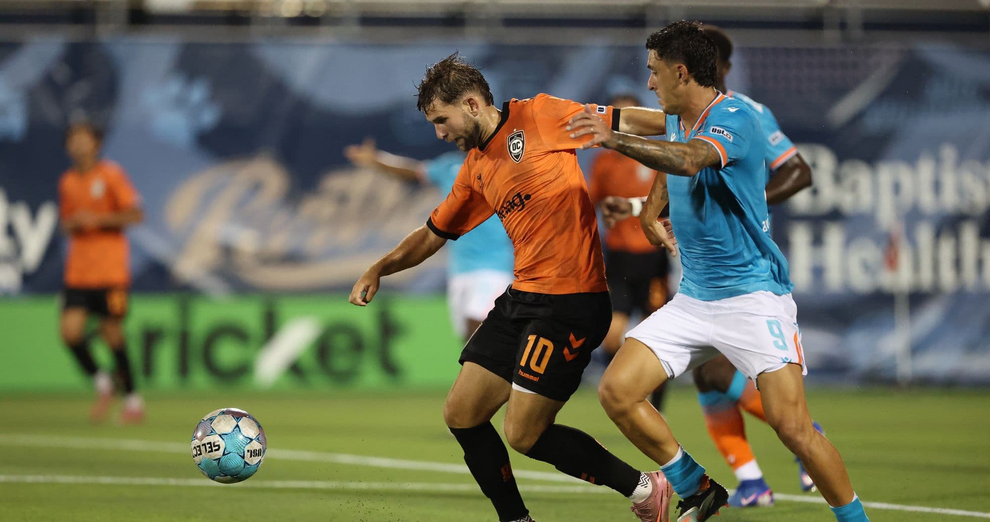 Dos jugadores compitiendo por el balón en el partido