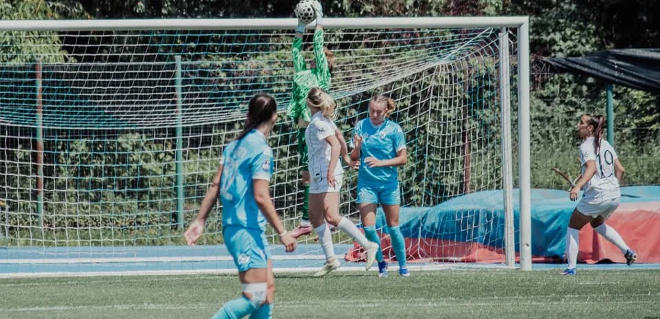 Portera atrapando el balón durante el partido