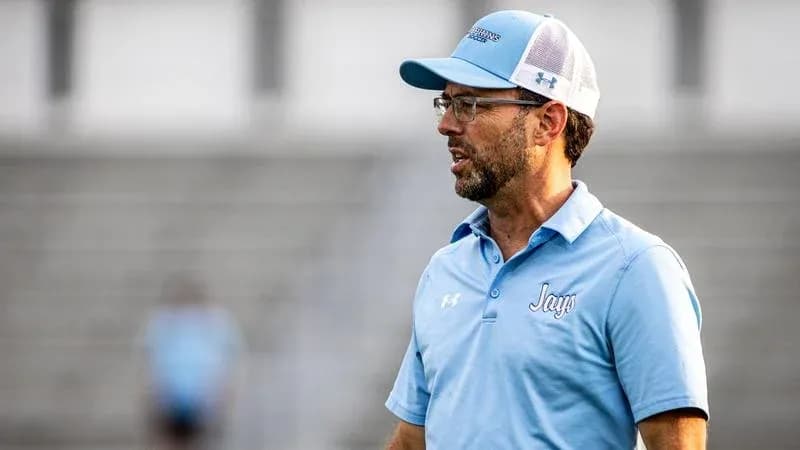 Entrenador dirigiendo a su equipo en el campo