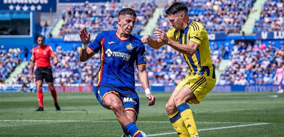 Jugador de Getafe tratando de evitar falta