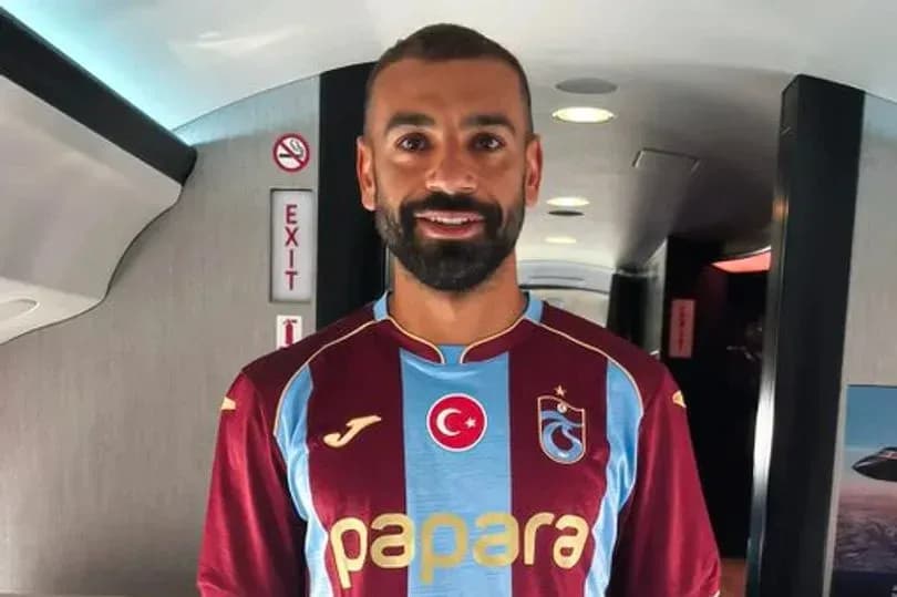 Jugador de fútbol con camiseta de Trabzonspor en avión