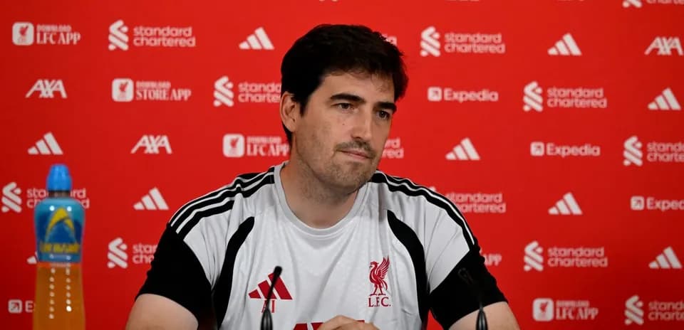 Entrenador en rueda de prensa con fondo rojo