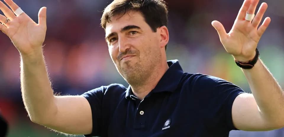 Entrenador saludando a la afición en el estadio