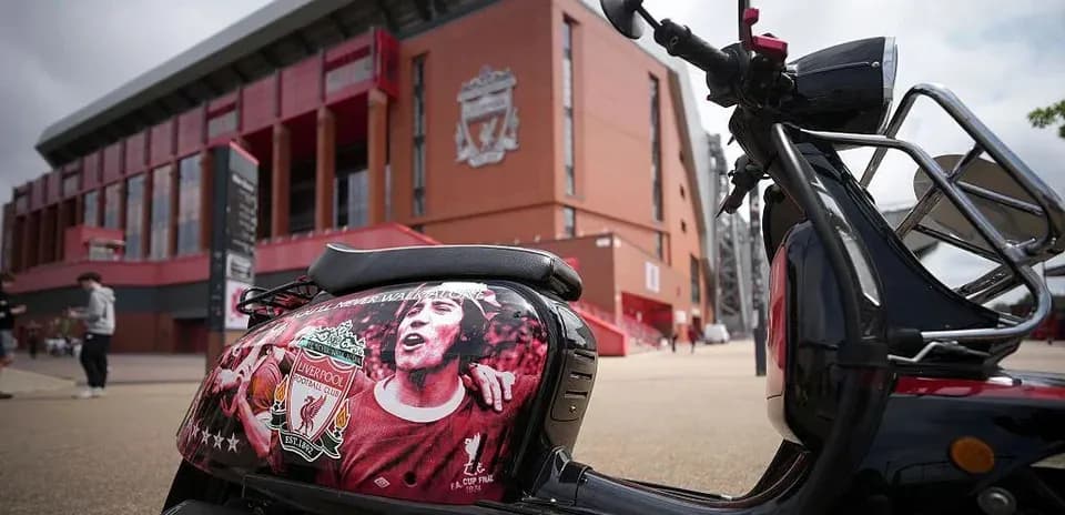 Scooter decorated with Liverpool FC logo outside stadium