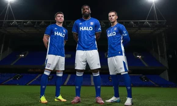 Tres jugadores posando en uniforme azul en el campo Tres jugadores posando en uniforme azul en el campo