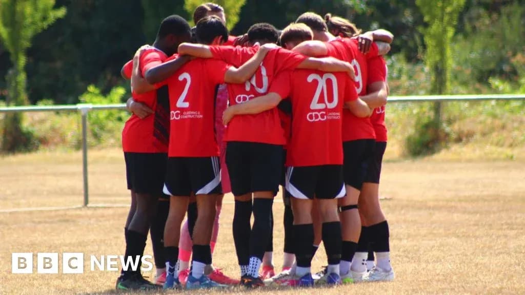 Equipo de fútbol en círculo durante un calentamiento Equipo de fútbol en círculo durante un calentamiento