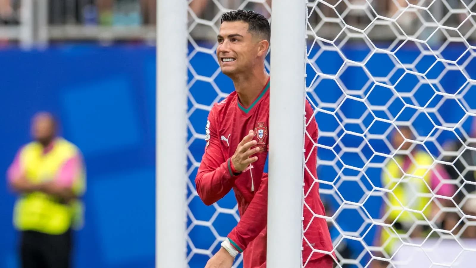 Cristiano Ronaldo celebrating behind goal net Cristiano Ronaldo celebrating behind goal net