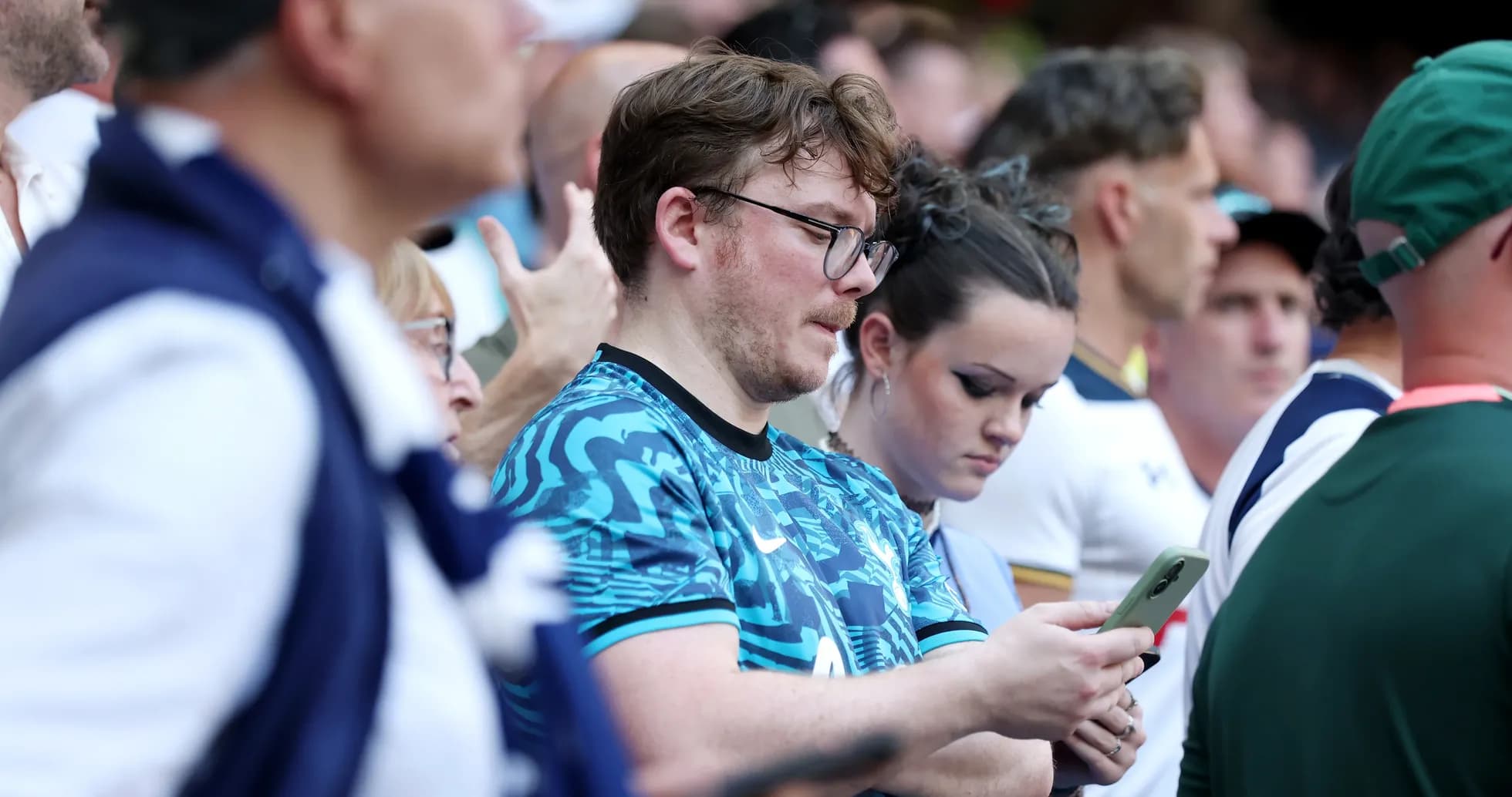 A crowd of fans watching a sports event A crowd of fans watching a sports event