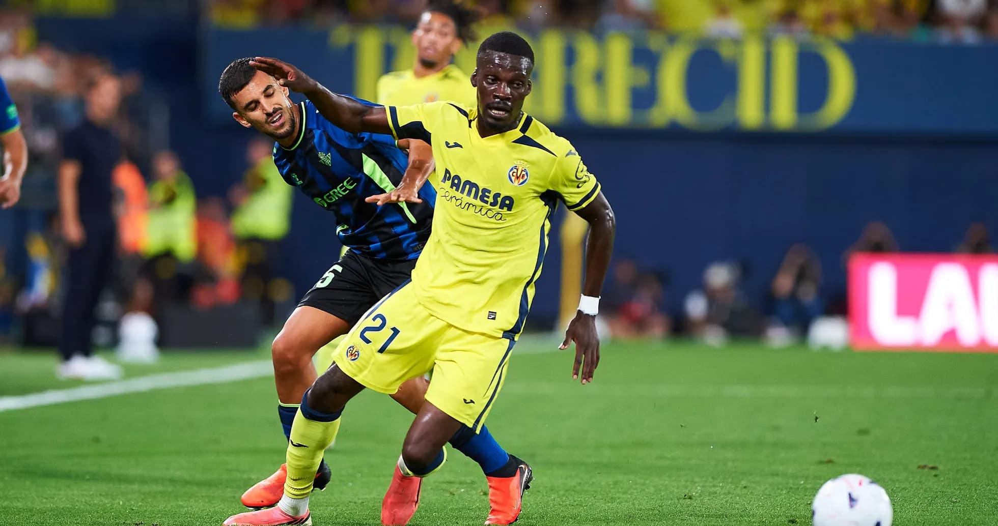 Jugador de Villarreal regateando a oponente de equipo rival Jugador de Villarreal regateando a oponente de equipo rival