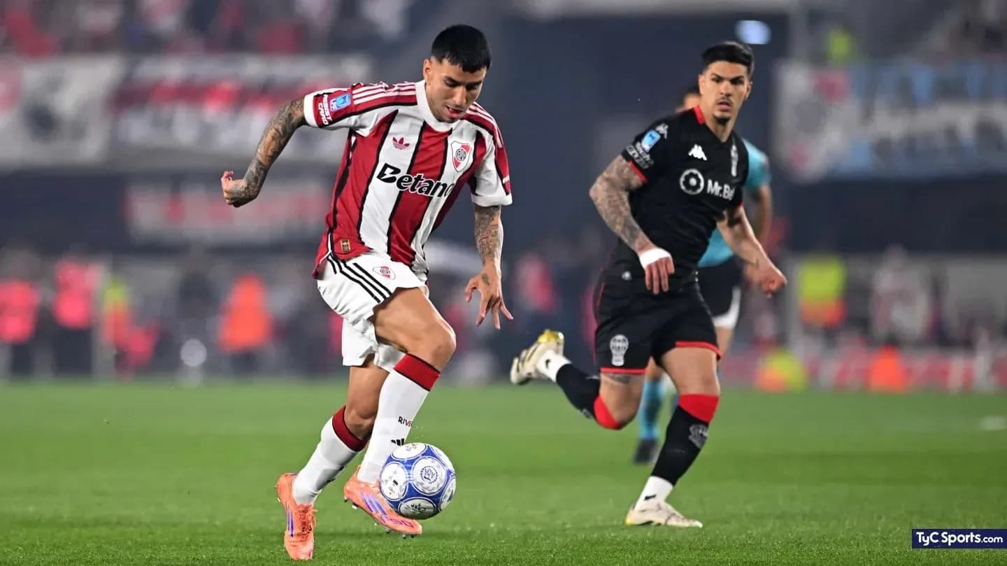 Jugador de River Plate driblando a oponente de Huracán Jugador de River Plate driblando a oponente de Huracán