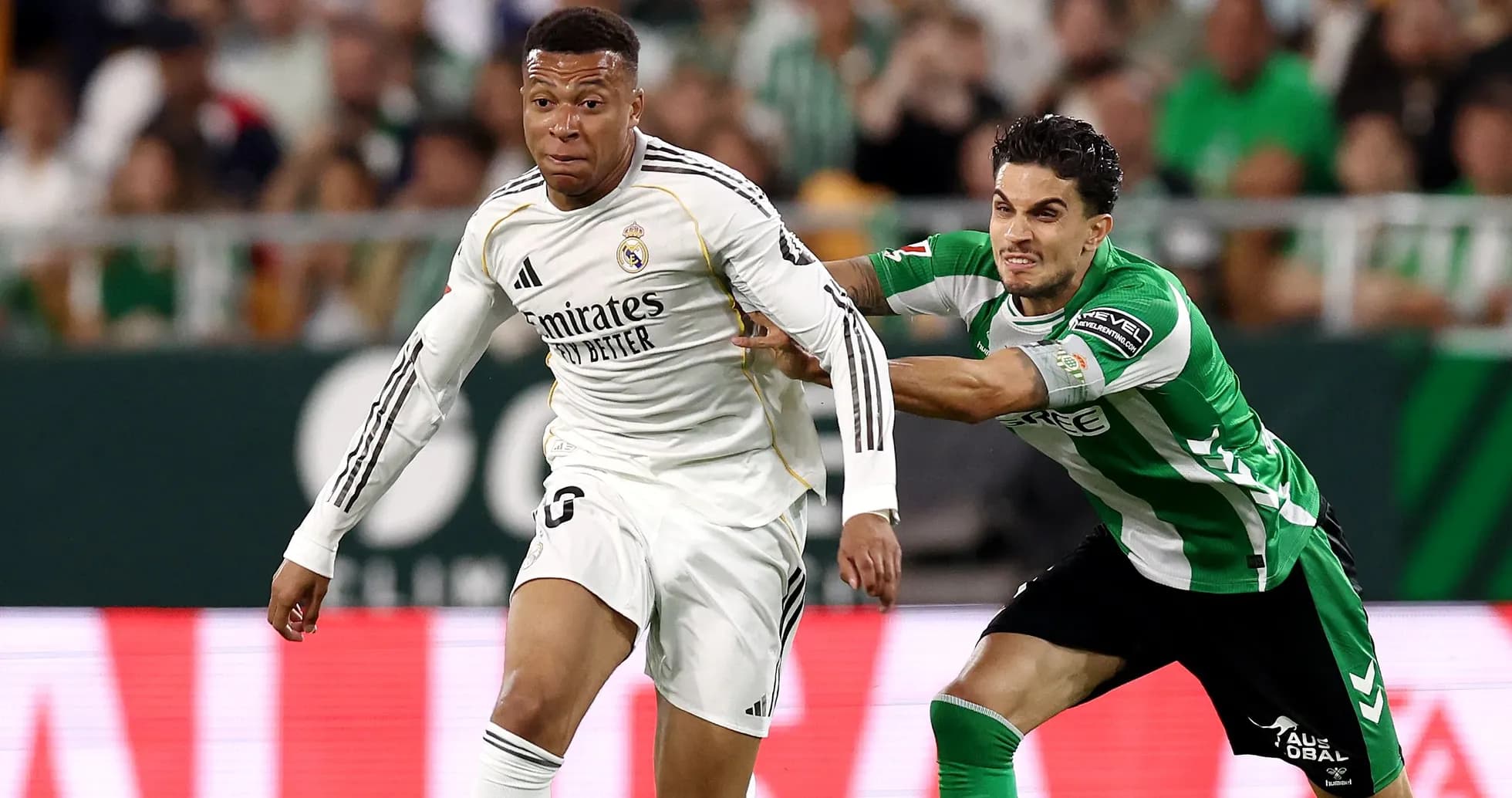 Jugador de Real Madrid driblando a oponente de Betis Jugador de Real Madrid driblando a oponente de Betis